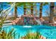 Backyard pool featuring a waterfall and palm trees for a resort-like oasis at 9504 Empire Rock St, Las Vegas, NV 89143