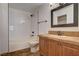 Bathroom featuring classic vanity, decorative mirror and shower-tub combination at 9655 Lame Horse Dr, Las Vegas, NV 89123