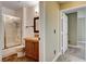 Bathroom featuring a glass door shower and sink with wooden cabinetry at 9655 Lame Horse Dr, Las Vegas, NV 89123