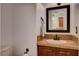 Half bathroom featuring wood cabinets and tile countertops at 9655 Lame Horse Dr, Las Vegas, NV 89123