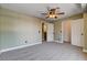 Bedroom with plush carpet, ceiling fan, bathroom door and walk in closet at 9655 Lame Horse Dr, Las Vegas, NV 89123