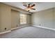 Bedroom with plush carpet, a ceiling fan, and a sunny window with a view at 9655 Lame Horse Dr, Las Vegas, NV 89123