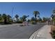 Stone Canyon entrance featuring mature palms, landscaping, and stone signage at 9655 Lame Horse Dr, Las Vegas, NV 89123