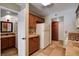 Open kitchen with wood cabinetry, light appliances, and convenient access to a half-bath at 9655 Lame Horse Dr, Las Vegas, NV 89123