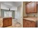 Well-lit kitchen featuring natural wood cabinets and access to the main living areas at 9655 Lame Horse Dr, Las Vegas, NV 89123