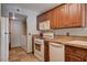 Kitchen featuring wood cabinets, white appliances, and tile countertops at 9655 Lame Horse Dr, Las Vegas, NV 89123