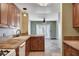 Stylish kitchen with wood cabinets, tile counters, and access to dining room at 9655 Lame Horse Dr, Las Vegas, NV 89123
