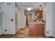 Galley kitchen featuring wood cabinets, tile flooring, and neutral paint colors at 9655 Lame Horse Dr, Las Vegas, NV 89123