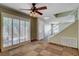 Bright living room featuring tile flooring, ceiling fan, and sliding glass doors at 9655 Lame Horse Dr, Las Vegas, NV 89123