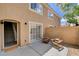 Private patio with two wood chairs and stairs leading inside, offering a relaxed outdoor space at 9655 Lame Horse Dr, Las Vegas, NV 89123