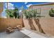 Private patio with seating, brick wall, and lush landscaping offers a serene outdoor living space at 9655 Lame Horse Dr, Las Vegas, NV 89123