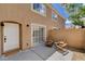Private patio featuring two wooden chairs with cushions and a sliding glass door leading inside at 9655 Lame Horse Dr, Las Vegas, NV 89123