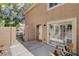 A private patio with a gate, offering seating and access to the interior through a sliding glass door at 9655 Lame Horse Dr, Las Vegas, NV 89123