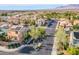 Scenic aerial view of a neighborhood with well-maintained homes, mature trees, and neatly paved streets at 9831 Running Rabbit St, Las Vegas, NV 89143