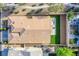 Birds-eye-view of backyard with green turf, patio, surrounding walls and landscaping and entire roof of property at 9831 Running Rabbit St, Las Vegas, NV 89143