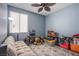Cozy bedroom with neutral carpet and ample natural light, perfect for relaxation and personalization at 9831 Running Rabbit St, Las Vegas, NV 89143