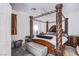 Bedroom featuring a four-poster bed, a ceiling fan, and neutral decor at 9831 Running Rabbit St, Las Vegas, NV 89143