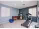 Versatile bonus room with ample light and tiled floors, ideal for a home gym or office space at 9831 Running Rabbit St, Las Vegas, NV 89143