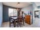 Dining room featuring a modern chandelier and a large window for natural light at 9831 Running Rabbit St, Las Vegas, NV 89143
