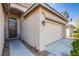 Inviting home exterior featuring a well-maintained lawn, a two-car garage, and a charming covered entryway at 9831 Running Rabbit St, Las Vegas, NV 89143