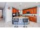 Open kitchen featuring stainless steel appliances, granite countertops, and a central island with bar seating at 9831 Running Rabbit St, Las Vegas, NV 89143