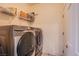 Well-equipped laundry room with modern appliances and convenient shelving for storage at 9831 Running Rabbit St, Las Vegas, NV 89143