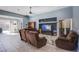 Spacious living room featuring tile floors, a ceiling fan, and seamless transition to the sliding doors at 9831 Running Rabbit St, Las Vegas, NV 89143
