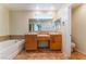 Beautiful bathroom featuring double sinks, bathtub, and a great vanity at 10457 Armand Ave, Las Vegas, NV 89129