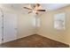 Cozy bedroom features a ceiling fan, neutral walls, and plush carpeting for a comfortable living space at 10457 Armand Ave, Las Vegas, NV 89129