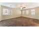 Spacious bedroom featuring neutral walls, carpeted floors, ceiling fan and natural light at 10457 Armand Ave, Las Vegas, NV 89129