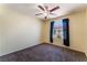 Bright bedroom with plush carpeting, large windows, and curtains that allow a lot of natural light at 10457 Armand Ave, Las Vegas, NV 89129