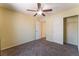 Comfortable bedroom featuring carpeted flooring, closet, and ceiling fan at 10457 Armand Ave, Las Vegas, NV 89129