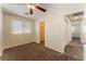 Comfortable bedroom with plush carpet, a ceiling fan, and a view of a spacious closet at 10457 Armand Ave, Las Vegas, NV 89129