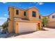 Two-story home featuring a two car garage, neutral stucco, and a red tile roof at 10457 Armand Ave, Las Vegas, NV 89129