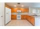 Spacious kitchen with tile floors, wood cabinets, and white appliances at 10457 Armand Ave, Las Vegas, NV 89129