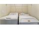 Convenient laundry area with a washer, dryer and shelving for easy storage at 10457 Armand Ave, Las Vegas, NV 89129