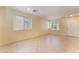 Expansive living room with tile flooring, neutral walls, and natural light through multiple windows at 10457 Armand Ave, Las Vegas, NV 89129