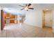 Open concept living room with tile flooring and staircase at 10457 Armand Ave, Las Vegas, NV 89129