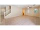 Open-concept living room with tile flooring, natural light, and staircase to the second level at 10457 Armand Ave, Las Vegas, NV 89129