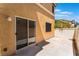 Cozy patio with neutral stucco and access to the home, perfect for outdoor relaxation at 10457 Armand Ave, Las Vegas, NV 89129