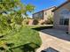 A well-maintained lawn, attractive patio, and lush landscaping define the beautiful backyard at 10650 Robin Hill Ave, Las Vegas, NV 89129