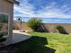 Lush green lawn, hardscape patio and a basketball hoop offer a backyard recreation area at 10650 Robin Hill Ave, Las Vegas, NV 89129