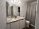 Bathroom with a modern vanity, large mirror, and a shower with curtain at 10650 Robin Hill Ave, Las Vegas, NV 89129