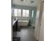 Bright bathroom featuring a soaking tub, dual sinks, and tiled floors at 10650 Robin Hill Ave, Las Vegas, NV 89129