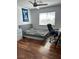 Neutral bedroom setup with hardwood flooring, ample natural lighting, a desk, and ceiling fan at 10650 Robin Hill Ave, Las Vegas, NV 89129