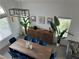 A birds-eye view of a dining room with a wooden table, seating for eight, and natural light at 10650 Robin Hill Ave, Las Vegas, NV 89129