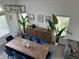 A birds-eye view of a dining room with a wooden table, seating for eight, and natural light at 10650 Robin Hill Ave, Las Vegas, NV 89129