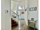Welcoming foyer with staircase, chandelier, and mirrored console table at 10650 Robin Hill Ave, Las Vegas, NV 89129