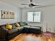 A comfortable living area with a sectional sofa, hardwood flooring, and a ceiling fan at 10650 Robin Hill Ave, Las Vegas, NV 89129