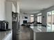 Open floor plan showcasing the kitchen with white cabinets and the living room with fireplace at 10650 Robin Hill Ave, Las Vegas, NV 89129